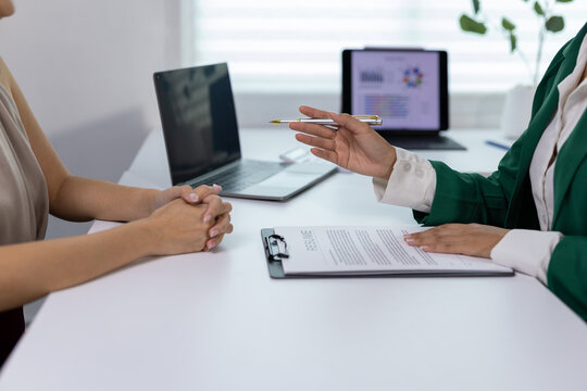 Recruiter explaining job details during interview with candidate.