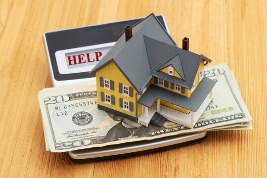 Help test with house with twenty dollar bill cash on wood desk