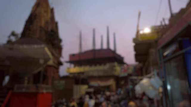 Bokeh evening view of Manikarnika Ghat is one of the ghats and is most known for being a place of Hindu cremation in Varanasi, India. Blurred background footage.