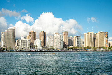 Obraz premium Modern high-rise hotels and resort skyscrapers lining the vibrant tropical waterfront along the Waikiki coast