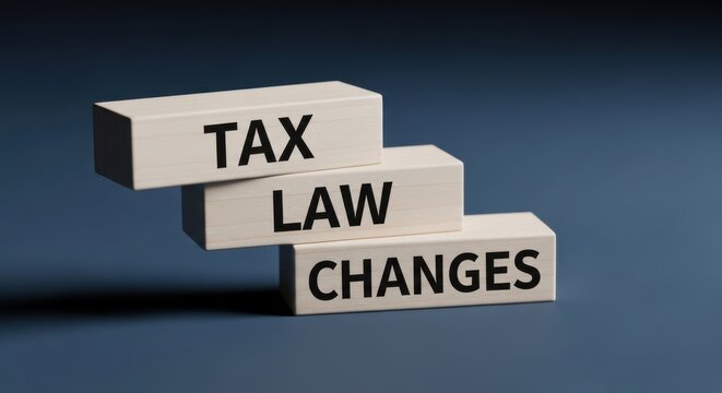 Tax law changes text on white wooden blocks, financial regulation and policy update concept, accounting and legal reform on blue background