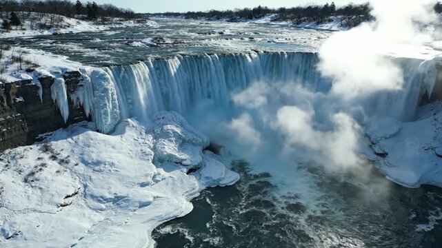 Stunning aerial view of the frozen Niagara Falls in winter, showcasing a breathtaking natural wonder.
