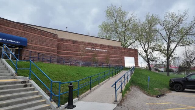 Calgary Alberta Canada, May 19 2026: Slow motion tracking shot up the sidewalk ramp at Norma Bush Memorial Arena
