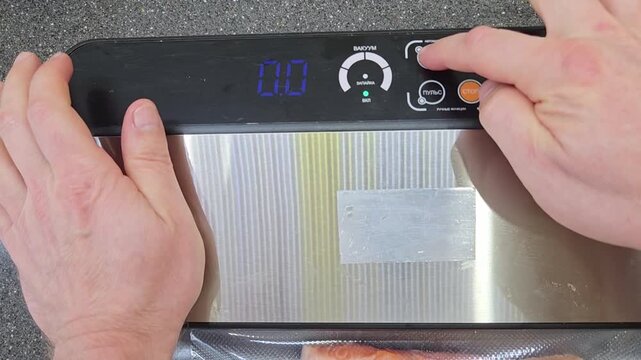Cooking salmon with a vacuum sealer at home in the kitchen