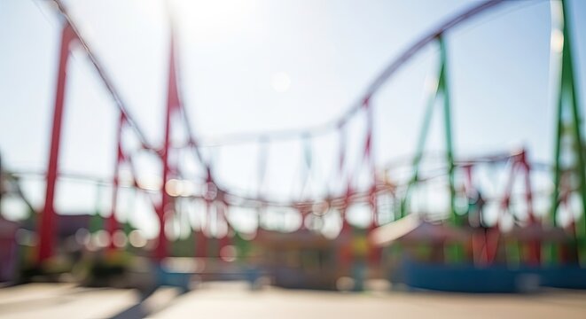 Blurred background of a vibrant roller coaster track against a bright sky.