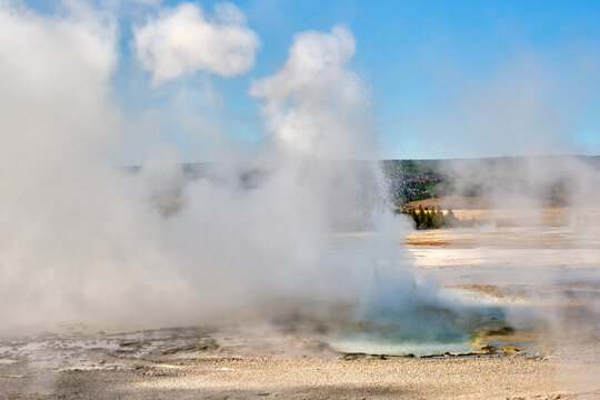 Clepsydra Geyser exhibits steam and water emissions during the evening.
