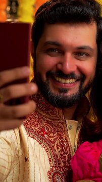 Video Calling While Lighting Diwali Samai, Indian Married Couple in Saree and Kurta Celebrate Festival Night by Lighting Traditional Brass Oil Lamp and Talking to Relatives via Smartphone with Smiles