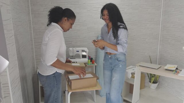 Mother and daughter packing small business orders