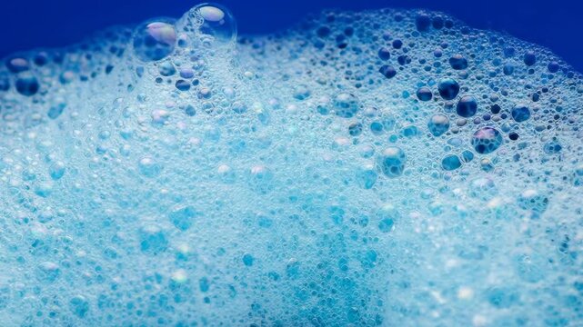 Light blue soapy foam with bubbles 
