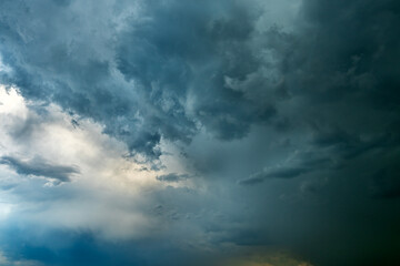 Fototapeta premium Dramatic dark storm clouds texture before rain in twilight sky.