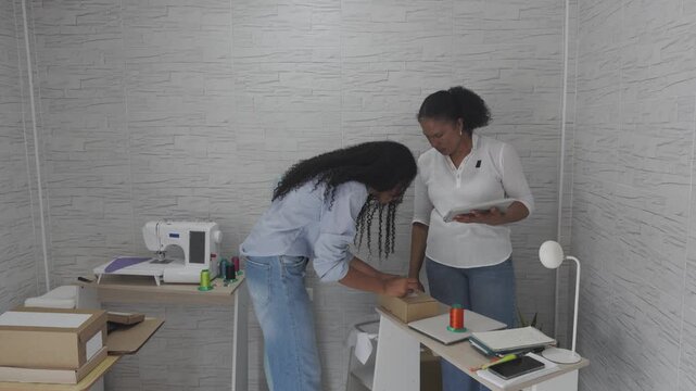 African american women managing a small tailoring business