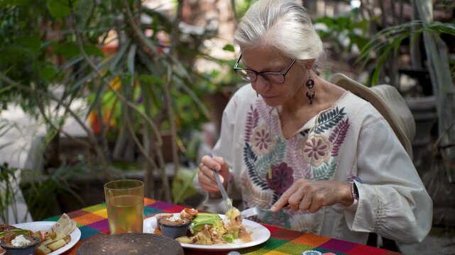 A mature woman tastes local dishes and explores the sights of Mulege in Baja California Sur during her visit to Mexico.