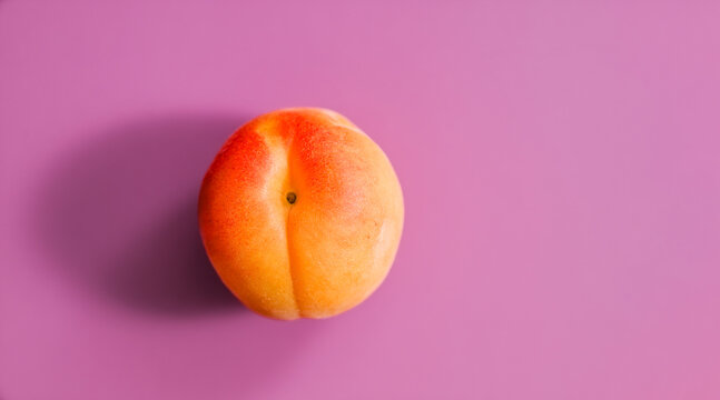 Ripe apricot with vivid orange and yellow tones centered on a saturated purple background, creating a fresh, colorful minimal still life perfect for food and lifestyle use