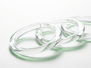 Fototapeta premium Elegant transparent glass rings on a clean minimalist white background