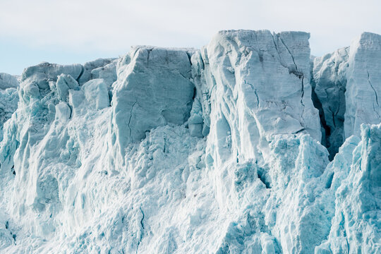 View of the massive blue ice wall of Lilliehookbreen glacier with deep cracks and textured frozen surfaces in Svalbard, Svalbard and Jan Mayen.