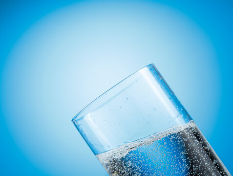 Clear drinking carbonated water in a tall glass.