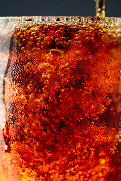 Fizz sparkling cola bubbly soda pop with ice cubes.