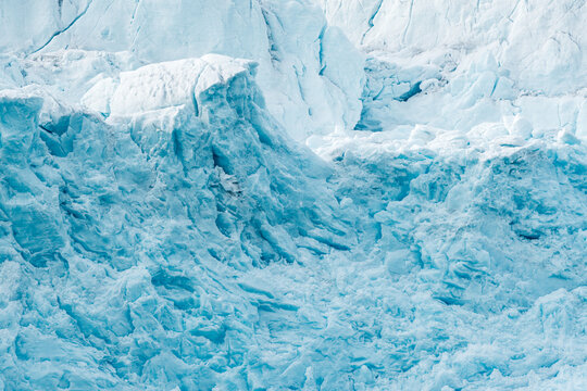 View of the massive blue ice wall of the Lilliehookbreen glacier featuring deep crevasses and jagged frozen textures in Svalbard, Svalbard and Jan Mayen.
