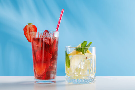 Fresh strawberry and lemon non alcoholic drinks with mint on blue background