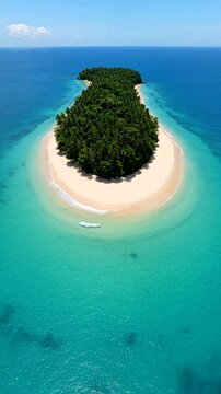 A stunning aerial view of a tropical island surrounded by crystal clear waters and pristine beaches.