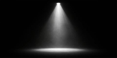 Obraz premium Dramatic single spotlight shining on dark stage floor with soft fog, creating moody atmosphere perfect for theatrical performances, concerts, and events