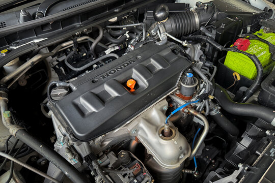 PENANG, MALAYSIA - MAY 11, 2026: Honda car engine bay with visible engine cover and automotive components inside vehicle hood compartment.