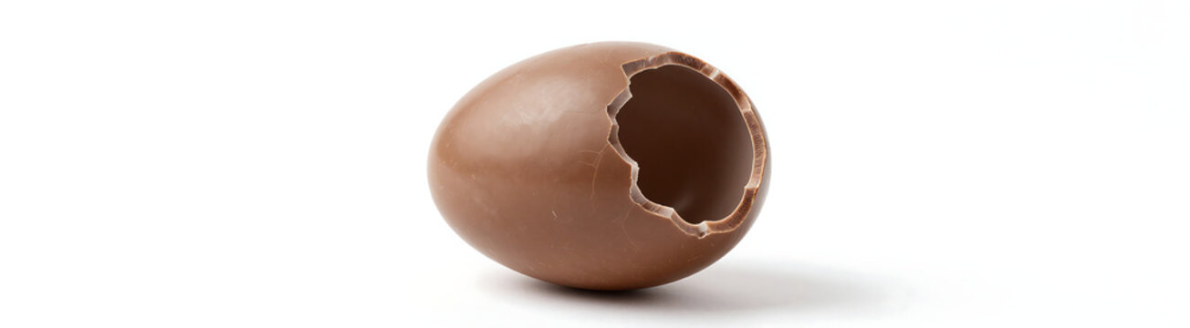 large cracked milk chocolate easter egg positioned centrally pristine white studio backdrop soft diffused lighting casting subtle