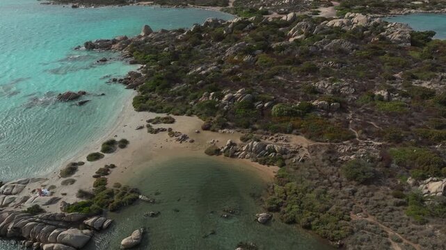 Stunning top down aerial view of a wild and beautiful coastline with turquoise water, sandy beaches and granite rocks in Sardinia, Italy