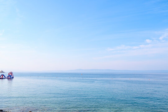 Sea surface of an absolutely calm water area during midday.