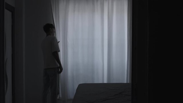 Paranoia and anxiety concept with suspicious person carefully looking through curtain, psychological fear, stress and unsafe feeling atmosphere