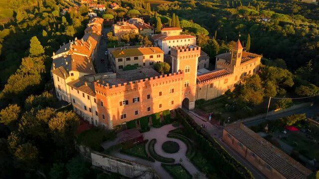 Bolgheri Italy 4k drone footage of medieval borgo village in Tuscany at sunset. Aerial view of luxury Tuscan countryside with golden hills and soft evening light cinematic orbit flight b-roll