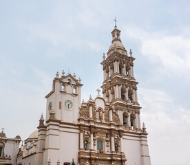 Fototapeta premium Low Angle Street Photography of the Historic Baroque Facade and Bell Tower of the Monterrey Metropolitan Cathedral on a Cloudy Day with No People in Downtown Nuevo Leon Mexico