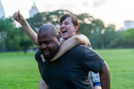 Joyful piggyback ride in park