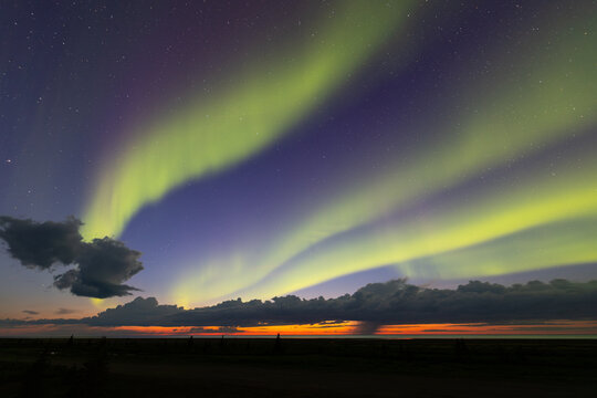 Green northern lights dancing over the northern Canadian coastline. Nanuk Polar Bear Lodge, York Factory, Manitoba.