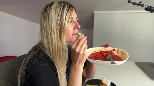 Brighthaired Female Takes Contemplative Pause While Eating Alone At Table During Study Break