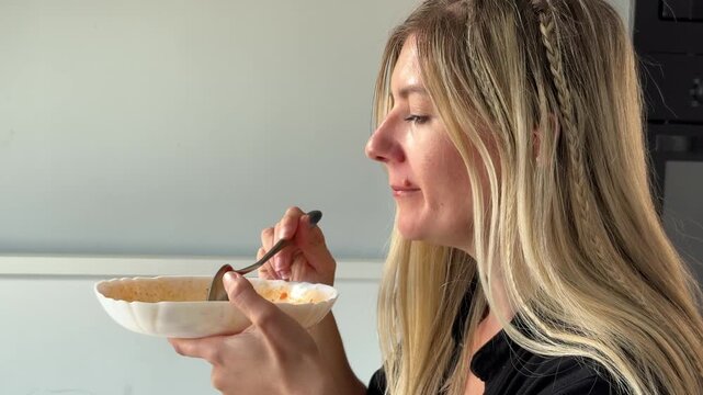 Blonde White Woman Smelling Tomato Soup For Seasoning Closeup Spoon Lifted Bowl Steam Simmer Countertop Home