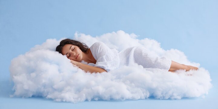 woman is sleeping on a cloud - naptime in a soft comfortable cloud in the sky