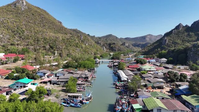 Aerial Drone View Of Coastal Fishing Village Thailand
Aerial drone footage of coastal fishing village near Thung Sam Roi Yot with mountains and boats in Thailand on 19 May 2026.
