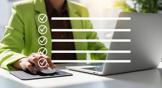 Person in green jacket using computer with checklist and checkmarks laptop mouse