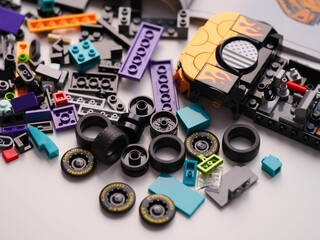 Obraz premium Tambov, Russian Federation - January 01, 2026 Lego Speed Champions Nascar Next Gen Chevrolet Camaro car kit build in progress with bricks, blocks, pieces, tires and instructions
