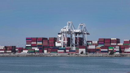 Naklejka premium Seaport with operating cranes and stacked containers