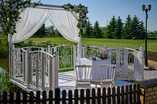 Outdoor wedding altar and ceremony area overlooking a pond and meadow, Poland, Europe.