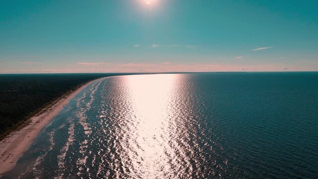 Aerial drone view of Jurmala beach and Lielupe river, Latvia. Baltic sea coast bordered by dense green pine forests.