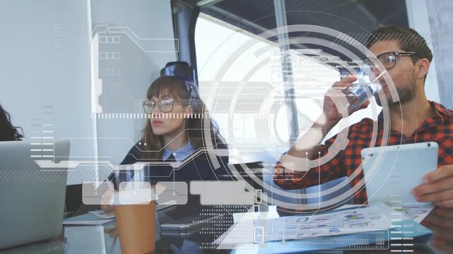 Coworkers reviewing charts and tapping tablet, activating HUD analytics during business meeting