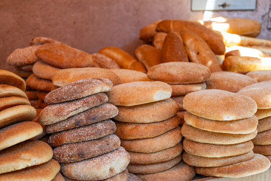 Stacks of freshly baked traditional Moroccan flatbread khobz at a street market