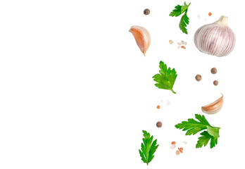 Fototapeta premium Garlic parsley peppercorns and salt arranged as food border isolated background for menu design recipe or advertising.