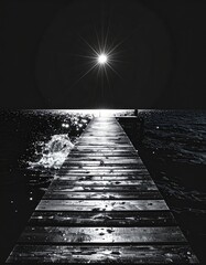 Obraz premium Pier leading to a bright starburst on the water at night monochrome