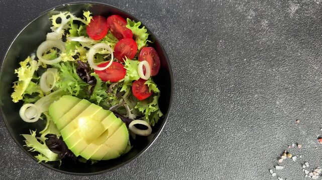 Avocado salad vegetables, tomato, green lettuce tasty snack fresh gourmet food, background on the table rustic food top view copy space keto and paleo diet vegetarian and vegan food