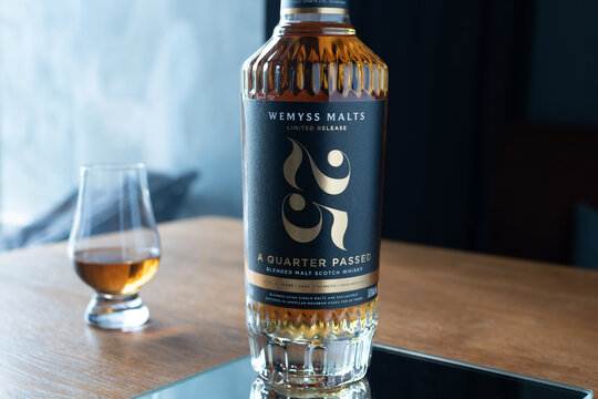 Wemyss Malts 25 years old Scotch whisky bottle with a tasting glass standing on a mirror reflection surface. Premium luxury alcohol. Ukraine, Zhytomyr, May 21, 2026