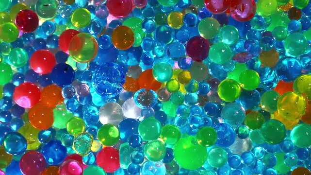 Colorful transparent water beads background with vibrant gel spheres texture